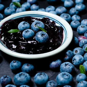 Blueberries and blueberry jam in a small bowl